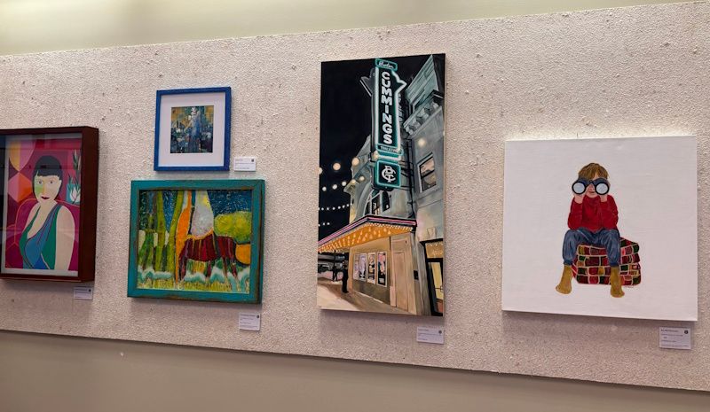 Four paintings in an art gallery in a row